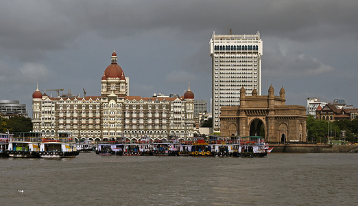 General view of Taj Mahal Palace Hotel (L) and Gateway of India (R) is seen from Arabian sea in Mumbai. The iconic monument and the five star hotel is a major tourist attraction opposite to each other. This is a must visit place in any tourist itinerary visiting the city which is close by to the Arabian sea to enjoy the view and click memorable photos.