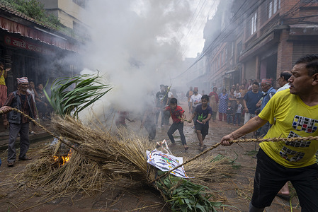 A Nepalese devotee pulling the burning effigy of Ghantakarna demon during the celebrations.
Ghantakarna festival is a celebration in defeat of the mythical demon Ghantakarna, chasing the evil spirits and bringing good fortunes.