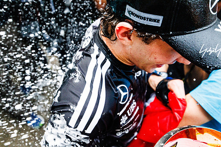 Andrea Kimi Antonelli of Italy and the Mercedes-AMG PETRONAS Formula One Team (R) celebrates with his team after winning the F1 Grand Prix of Japan at the Suzuka Grand Prix Circuit in Suzuka, Japan.