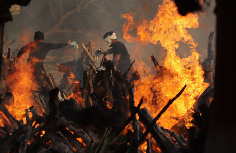 Relatives stand next to the burning funeral pyres of those who died due to the coronavirus disease (COVID-19), at Ghazipur cremation ground in New Delhi.
In India the highest single-day spike in coronavirus infection. The report recorded 352,991 new Covid-19 cases and 2,812 deaths in the last 24 hours amid an oxygen crisis.