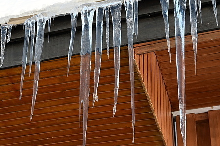 Several ice cubes seen on the roof of a wooden house at the Alpe d'Huez ski resort.