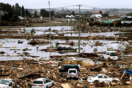 Debris from houses and vehicles lies scattered across the flooded city of Rikuzentakata, Iwate Prefecture, Japan, after a massive tsunami left many people missing following the March 11, 2011 Great East Japan Earthquake and disaster.