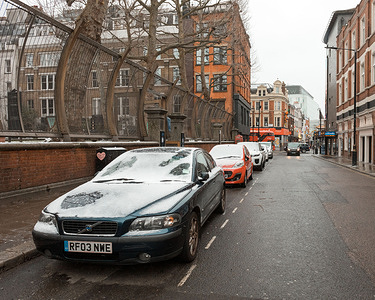 Cars parked on a road in Soho covered with snow as snow falls in the city.
London has been experiencing snow as the Storm Darcy hits the city.