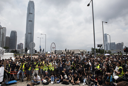 Photojournalists photograph media colleagues during a silent march demanding police to stop assaulting journalists and obstructing reporting in Hong Kong.