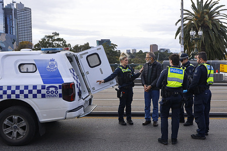 Victoria Police arrest a protester during a climate demonstration. A protest was held in Melbourne in response to the Australian government’s decision to approve a 40-year extension of Woodside Energy’s North West Shelf gas project, allowing it to operate until 2070. Critics have condemned the project as a “carbon bomb,” warning it could emit up to 4.3 billion tonnes of greenhouse gases. The approval has drawn strong opposition from environmental groups, climate activists, and Indigenous communities concerned about the impact on Murujuga rock art and Australia’s international climate obligations. The Albanese government maintains the project is vital for energy security, but protesters argue it represents a significant betrayal of climate commitments.