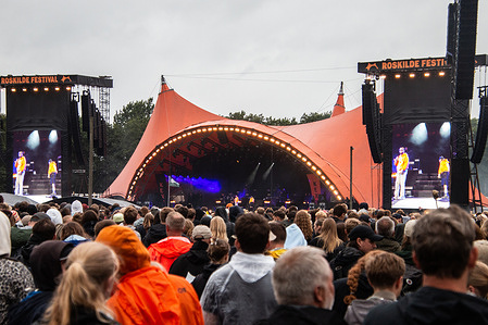 Festival goers seen in front of the Orange Stage at a live concert with the rap stars Kian Rosenberg Larsson known professionally as Gilli and Benjamin Jacob Small Heyn Johnsen also known as Benny Jamz with an exclusive show for their Kenny project at Roskilde Festival 2025. The festival is the largest of its kind in the Nordics with an expected 130,000 participants during the 7 days the festival spans. The camping area opens four days before the festival.