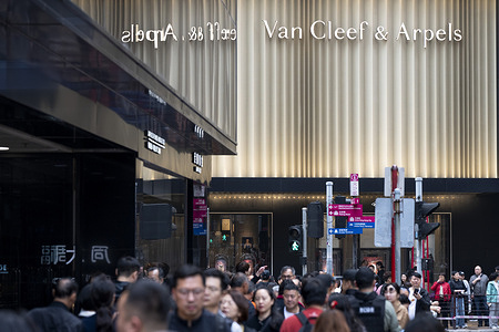 Pedestrians are seen in front of the French luxury jewellery, watch, and perfume company, Van Cleef & Arpels, store in Hong Kong.