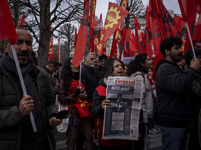 A member of the Labor Party, holds up a copy of the Evrensel newspaper with the headline "NATO Get Out" and chants slogans during the rally. A large number of people gathered in Istanbul for a demonstration held on the anniversary of NATO's founding. The crowd, which assembled in front of the AKM (Atatürk Cultural Center), marched to Dolmabahçe Palace, calling for the dissolution of NATO and Turkey's withdrawal from the alliance.