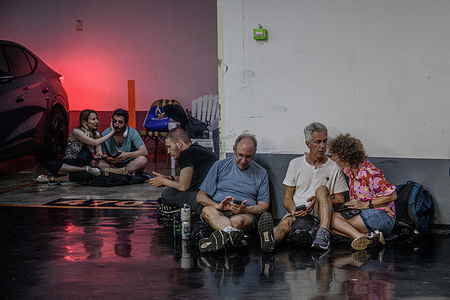 Israelis seen taking shelter in a public underground facility during an Iranian ballistic missile barrage. Israelis gather at public shelters during an Iranian retaliatory missile attack in response to Israel’s strikes against Iran’s nuclear and military facilities.