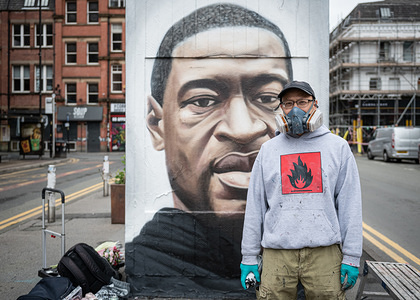 A portrait of the street artist, Akse P19, having just completed his mural of George Floyd.