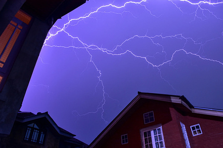 A flash of branching lightning illuminates the purple-blue stormy sky during a thunderstorm in Srinagar, the summer capital of Jammu and Kashmir. Weather authorities have issued an advisory for Jammu and Kashmir as a fresh Western Disturbance approaches the region. The meteorological system is anticipated to break dry conditions by bringing scattered light rain, localized thunderstorms, and strong winds.