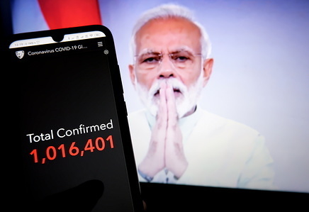 In this photo illustration a total global number of people confirmed infected with Covid-19 seen displayed on a mobile phone in a background Indian Prime Minister Narendra Modi.
India Reported 2100 infected case & 55 Death as on 3rd April due to Coronavirus outbreak.