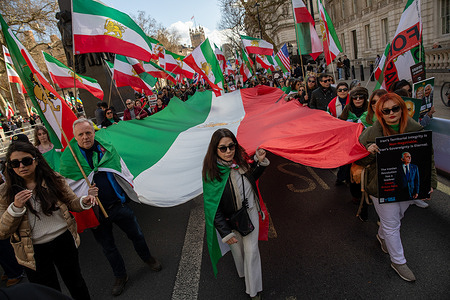 Protestors carry an Iranian Monarchist flag during a demonstration in London. As the war between the United States, Israel and Iran continues, supporters of Crown Prince Reza Pahlavi gathered in central London for a march and rally. Demonstrators voiced support for the US-led military action and called for the exiled son of the former Shah to serve as a unifying figurehead should Iran’s current regime be overthrown.