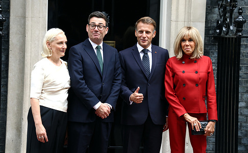 British Prime Minister Andy Burnham and his wife, Marie-France van Heel, pose for photos with French President Emmanuel Macron and his wife Brigitte Macron outside 10 Downing Street.