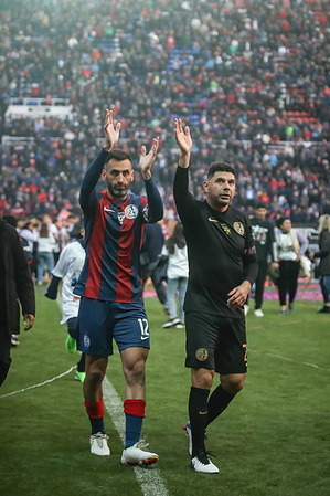 Sebastian Torrico (L) and Nestor Ortigoza (R) wave farewell to their fans at an emotional tribute, the champions of America in 2014 with San Lorenzo, said goodbye to soccer at Pedro Bidegain Stadium in Buenos Aires.