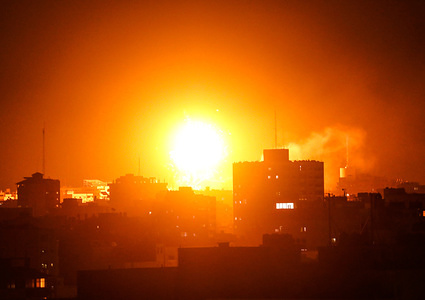 A picture taken on November 12, 2018, shows a ball of fire above the building housing the Hamas-run television station al-Aqsa TV in the Gaza Strip during an Israeli air strike. - Israel's military said it was carrying out air strikes "throughout the Gaza Strip" after rocket fire from the Palestinian enclave towards its territory.