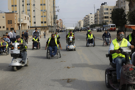 Palestinian handicapped take part in a marathon calling for the opening of Gaza border to the outside world in Khan Younis in the southern Gaza Strip.