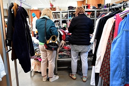 People seen shopping clothes at Emmaus Spring Sale. Spring clothing sale at Emmaus to support the association's activities and provide housing for the most vulnerable in the town of Serrières.