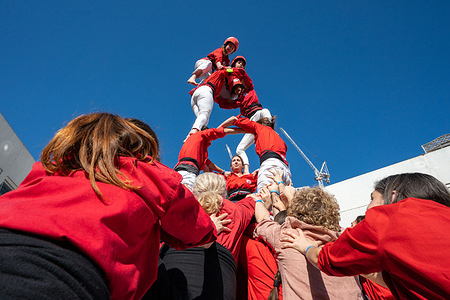 Performers in formation. Members of Castellers of London performed traditional “castells” or human towers during a public display at The Blue Market in Bermondsey. The group, inspired by the Catalan cultural tradition, assembled multi-level human structures in front of gathered crowds, showcasing teamwork, balance and community spirit as families and visitors watched the performance in the market square.