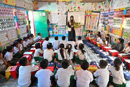 Rohingya children attend classes at a regular learning center inside the camp. Around one million Rohingya refugees live in the camps of Cox's Bazar. In 2017, waves of Rohingya refugees fled ethnic violence in Rakhine State in Myanmar, joining earlier waves of displacement that began decades ago. Amid overcrowded shelters, limited mobility, and prolonged statelessness, the Rohingya have built vibrant community spaces, preserved cultural traditions, and adapted to a challenging environment. They continue to study, work, play, and celebrate life, demonstrating resilience and creativity in the face of adversity.