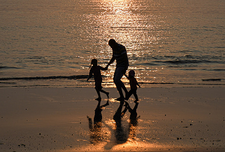 A man walks with children during sunset at the beach in Mumbai on Children's day. Children's day is celebrated every year on 14th November in India as it marks the birthday of the first Prime Minister of India, Pandit Jawaharlal Nehru, who was fond of children. The day is celebrated in honor of children and to create awareness about children's education, rights and safety.