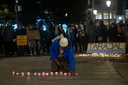 A man lights candles during the demonstration. People gather in the Lavapiés neighborhood of Madrid to commemorate the twelfth anniversary of the deaths of 14 African migrants on Tarajal beach while attempting to cross from Morocco to Ceuta.