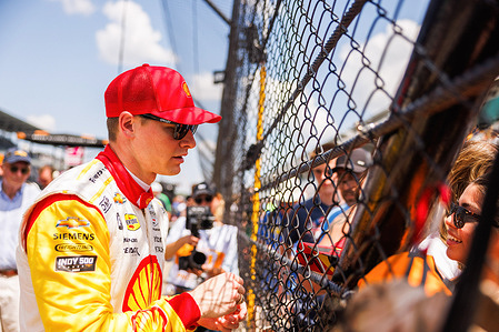 Indy car racer Josef Newgarden (2), of Team Penske, signs autographs during the 'Fast 12' practice for the 2024 Indy 500 at Indianapolis Motor Speedway.