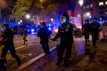 Riot police are seen charging against the crowd during the demonstration. Demonstrations were called in cities all over Spain following the eviction of Maricarmen Abascal, an 87-year-old woman evicted from her apartment after a real estate agency bought it, and the Spanish parliament's rejection of a decree aimed at strengthening protections for tenants.