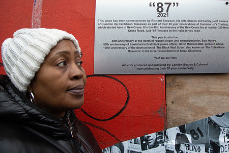 Maggie Edwards who jumped out of the burning house when she was 3 months pregnant looks at mural honoring those who died in the fire including her sister 41 years ago. 
The New Cross house fire occurred during a party at a house in New Cross, on 18th January 1981. The blaze killed 13 young black people and one survivor took his own life two years later. No one has ever been charged in connection with the fire.