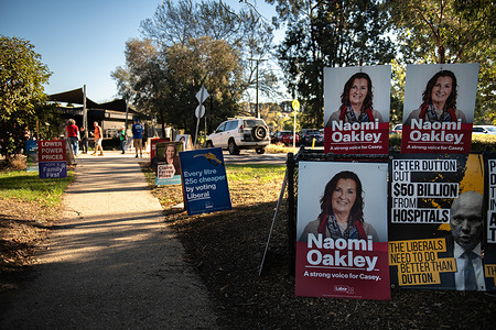 Campaign posters are seen along a walkway leading to the polling place in Chirnside Park. Early voters head to the polls in Chirnside Park before the 2025 Australian Federal election. The seat of Casey has been held by the Liberal Party since 1984 and is currently at a very slim margin.