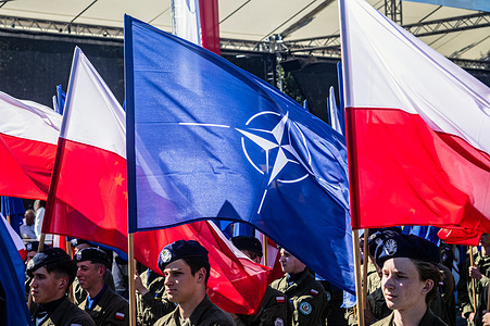 Soldiers bring up the rear of the parade with NATO and Polish flags. Poland celebrates its Armed Forces Day with a military parade under the slogan "Poland SAFE – A Secure Poland" promoting the country's inclusion in the Security Action for Europe defence-financing programme. Poland's armed forces, along with allied troops stationed in the country, participated in a parade in front of the public, the media, and assembled dignitaries. Before the parade, Poland's Deputy Prime Minister and Minister of National Defence, Wladyslaw Kosiniak-Kamysz, and Poland's President, Karol Nawrocki, addressed the public and the assembled media. The parade featured soldiers, mechanised divisions, tanks, various armoured vehicles, and a fly-over by members of Poland's Air Force, including the recently purchased F35 fighter jets.