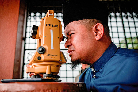 An official from the Selangor Islamic Religious Council is performing "rukyah", a moon sighting ceremony to determine the start date of the holy month of Ramadan in Bukit Malawati.