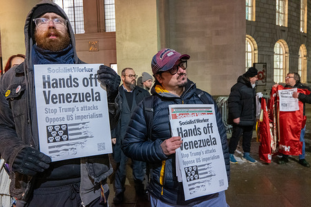 Protesters hold placards saying Hands off Venezuela during the demonstration. A protest was held in Manchester, UK against perceived U.S. military aggression in Venezuela, following the recent capture of Venezuelan President Nicolás Maduro. Groups including the Cuba Solidarity Campaign and the Stop the War Coalition, condemned the U.S. actions as an "act of war" and a violation of international law. Protesters gathered in sub zeros temperatures to listen to anti war speeches. Venezuelan flags and anti trump placards condemning the attack were held by protesters outside the Central library in St Peter's Square.