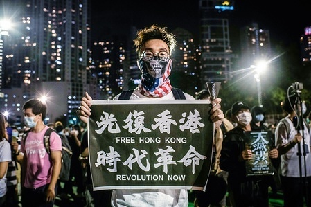 A pro-democracy protester holds a banner with pro-independency message during a memorial vigil at Victoria Park in the Causeway Bay district of Hong Kong.Thousands gathered for the annual memorial vigil in Victoria Park to mark the 1989 Tiananmen Square Massacre despite a police ban citing coronavirus social distancing restrictions.