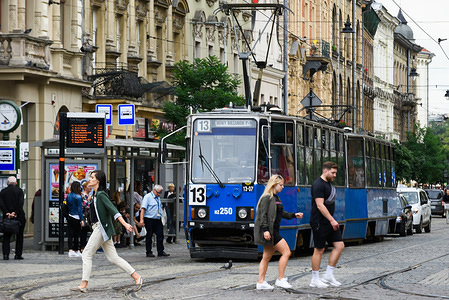 People walk by Teatr Bagatela tram stop in Krakow.
Krakow is the second largest city in Poland and it is located in the southern part of the country.