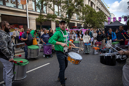 A Samba band plays in the middle of Oxford Street during a car free day. Following Mayor Sir Sadiq Khan’s proposal to pedestrianise Oxford Street. A car-free day was organised from 12:00 to 20:00 on 21st September 2025. To demonstrate the potential benefits of this initiative, the section between Oxford Circus and Marble Arch was closed to all vehicular traffic including cars, buses and taxis. This marks Mayor Khan’s second attempt to restrict traffic on Oxford Street following considerable opposition to a previous plan in 2018.