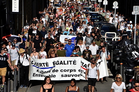 Protesters hold a banner during the demonstration against the health pass in Marseille.
Thousands of people demonstrated against the health pass in Marseille, France. French President Emmanuel Macron announced among new anti-Covid 19 measures a "health pass" which will be necessary for entering café terraces, restaurants, cinemas, theaters and other culture and leisure venues to help limit the spread of the Covid-19 virus.