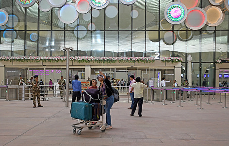 Passengers seen arriving with their luggage bags outside the departure entry gate at Navi Mumbai International Airport (NMIA). Commercial operations of flights started at the Navi Mumbai International Airport (NMIA) aimed at easing congestion at the Chhatrapati Shivaji Maharaj International Airport (CSMIA), marking an important milestone in infrastructure development. The airport was developed and being operated by Adani Airports Holdings Limited (AAHL), wholly owned subsidiary of Adani Enterprises Limited.
