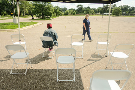 Health Care Workers from the Detroit Health Department wait for walk-up patients to arrive during a mobile vaccination clinic at East English Village High School.
Vaccination Clinics are being held at various dates through the rest of July and into August at 3 different public high schools in Detroit, Michigan. The clinics are part of an effort between the Detroit Health Department and the Detroit Public Schools Community District to administer as many vaccines as they can prior to the coming school year, and to try and curb the rising numbers of Delta variant Covid cases among those who are unvaccinated.