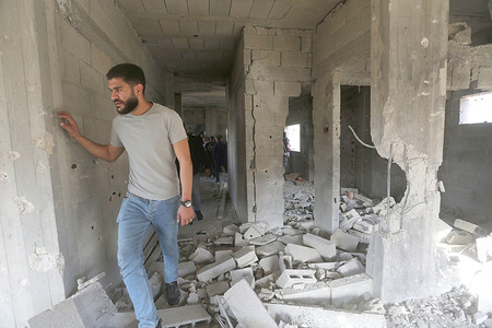 People inspect the house where two Palestinians were killed by Israeli forces during a raid in the Masaken al-Sha'biya neighborhood east of Nablus in the occupied West Bank. Israeli forces raided the city of Nablus and killed two Palestinians after surrounding the house where they were holed up and firing rockets at it.