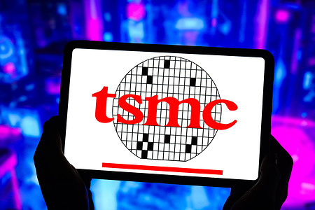 In this photo illustration, the Taiwan Semiconductor Manufacturing Company (TSMC) logo is displayed on the screen of a tablet.