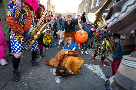 A contestant seen on the on the ground during the race. People in traditional pantomime horse costumes raced through the streets of Greenwich as the London Pantomime Horse Race returned for its 12th edition combining festive humour with charity. The light-hearted event saw costumed pairs compete along a short course while entertaining crowds.