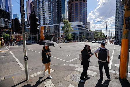 A woman with an umbrella is seen during peak 42 °C temperatures. Melbourne is experiencing an extreme heatwave, with temperatures in the city climbing to 42 °C as severe conditions grip Victoria and much of Australia. Heatwave warnings are in place nationwide, with forecast highs of 44 °C in Mildura, 41 °C in Adelaide, 36 °C in Canberra, and 31 °C in both Sydney and Brisbane, prompting authorities to urge precautions against heat-related illness.
