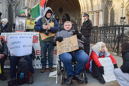 A blind protester in a wheelchair sits with a placard stating 'I oppose genocide, I support Palestine Action' during the demonstration outside the Royal Courts of Justice as the co-founder of the activist group Palestine Action, Huda Ammori, launches a legal challenge against the ban of the group under anti-terrorism laws. Hundreds of people gathered for a protest as part of the Lift The Ban campaign by the organisation Defend Our Juries.