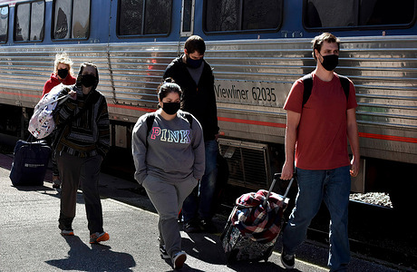 Rail passengers wearing face masks walk on the platform after exiting a train at the Orlando Amtrak station on the first day that the Transportation Security Administration (TSA) began requiring travellers to wear face masks when in airports, bus and rail stations, as well as while on passenger aircraft, public transportation, passenger railroads, and buses. 
This requirement implements President Biden's Executive Order on Promoting COVID-19 Safety in Domestic and International Travel, and will remain in effect until May 11, 2021.