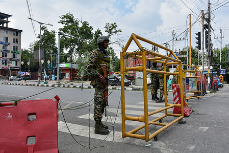 A paramilitary trooper stands alert at a temporary check-post during restrictions on the eve of Martyrs Day. July 13 marks the killing of 22 protesters outside Srinagar Central Jail in 1931, when Dogra forces opened fire on a crowd that had gathered during the trial of Abdul Qadeer, who had been arrested after delivering a speech against the Dogra monarchy.