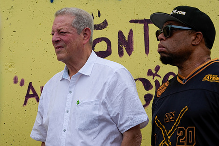 Vice President Al Gore watches speakers at the Hurricane Katrina memorial in the Lower Ninth Ward. Twenty years ago, Hurricane Katrina swept through the gulf coast and devastated New Orleans when the levees that protect the city broke, flooding 80% of the city.