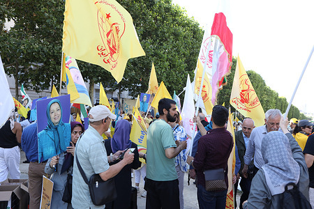 Supporters of the Iranian Resistance, NCRI, wave yellow flags of the People's Mojahedin Organization of Iran (PMOI/MEK) during the gathering near Place Vauban. Despite the last-minute ban on the Free Iran Rally, Organizers said more than 50,000 Iranians from around the world gathered at Place Vauban to condemn the regime's escalating wave of executions and express their support for Mrs. Maryam Rajavi's Ten-Point Plan for a democratic republic in Iran. French police prevented numerous buses carrying participants from reaching the rally site, while many attendees were turned back upon arrival at Charles de Gaulle Airport; several demonstrators were injured during police interventions and taken to the hospital for treatment.
