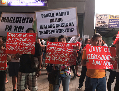 Protesters hold placards during the demonstration.
Women's group GABRIELA and other militant groups staged a Black Friday Protest demanding for a pro-people mass transport system. As Presidential Spokesperson Salvador Panelo's completion of "commute challenge" does nothing to appease the riding public's frustrations over the Metro Manila's mass transport mess.