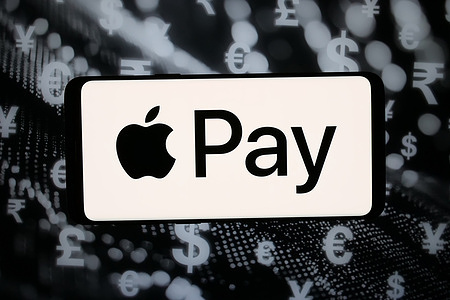 In this photo illustration, the logo of mobile payment service Apple Pay is displayed on a smartphone in front of abstract background on computer screen.
